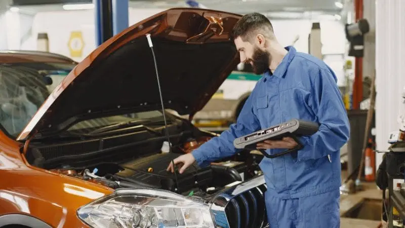 mechanic checking timing belt
